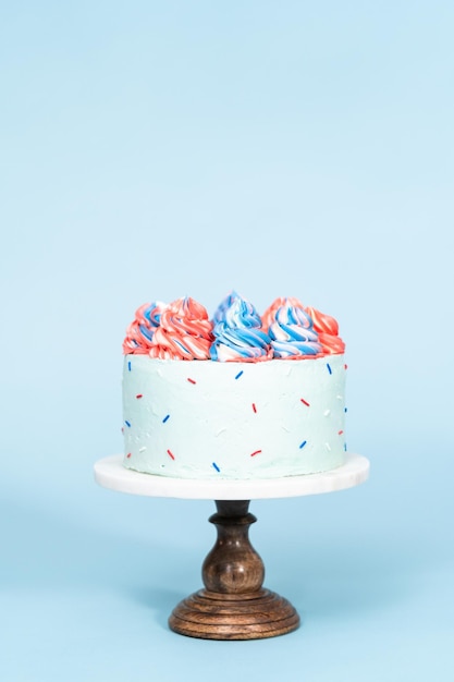 Red, white, and blue round cake frosted with buttercream frosting.