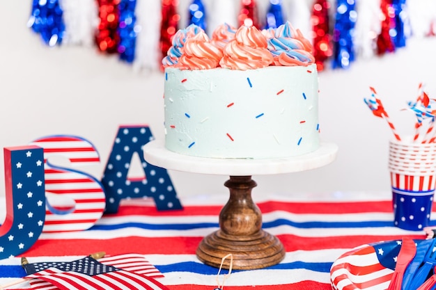 Red, white, and blue round vanilla cake with buttercream frosting for July 4th celebration.