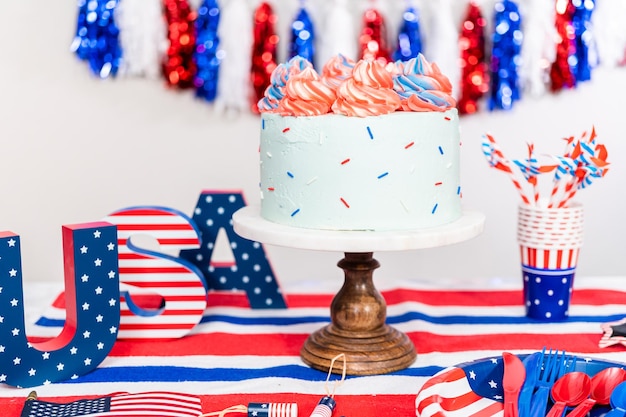 Red, white, and blue round vanilla cake with buttercream frosting for July 4th celebration.