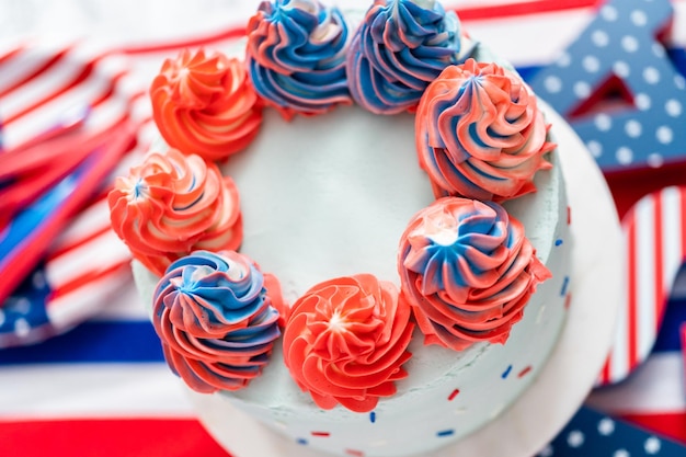 Red, white, and blue round vanilla cake with buttercream frosting for July 4th celebration.