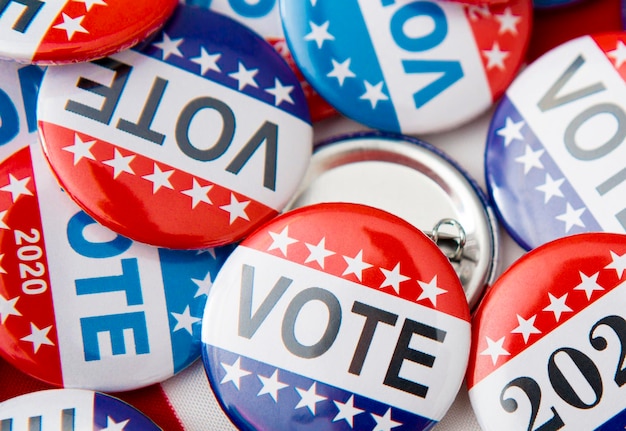 red white and blue vote buttons on background
