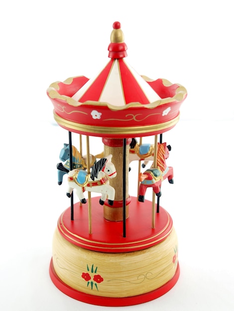 A red and white carousel with horses on it