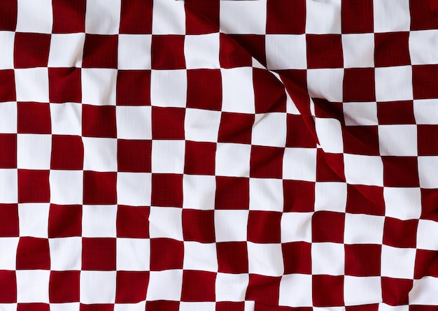 Photo a red and white checkered cloth with a pattern of squares.