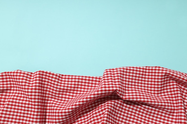 Red and white checkered tablecloth on blue background