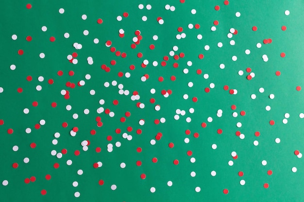 Red white confetti on green background carnival christmas new\
year birthday festive backdrop high