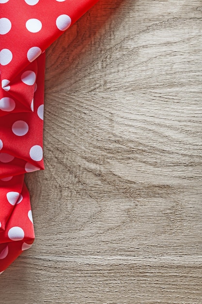 Red white cotton folded polkadot textile on wooden board