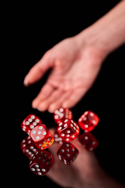 Red and white craps or dices on reflective black background