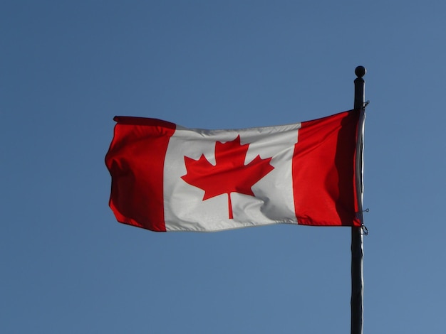 A red and white flag with a maple leaf on it