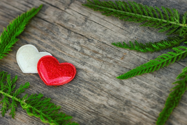 Red and white heart lie on wooden background