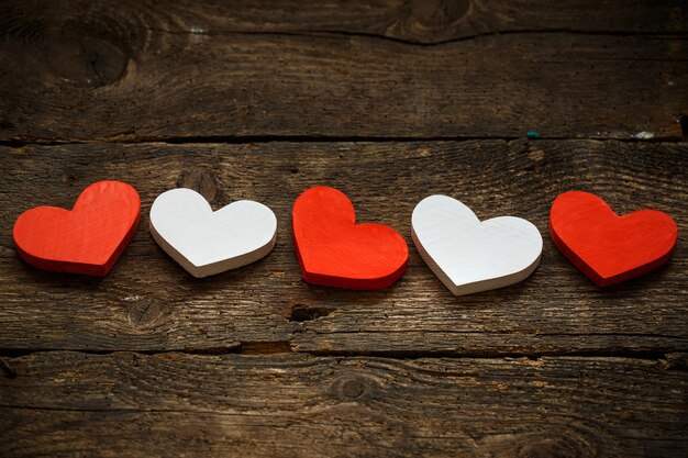 Red and white hearts on old shabby wooden background image of valentines day