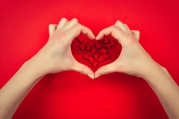 Red and white hearts on a red background Woman holding white heart Copy space