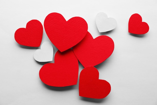 Red and white hearts on white paper background