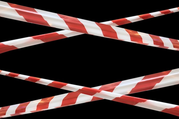 Red and white lines of barrier tape prohibit passage tape on\
black isolate background