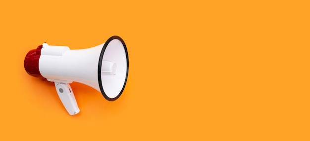 Red and white megaphone on orange background.