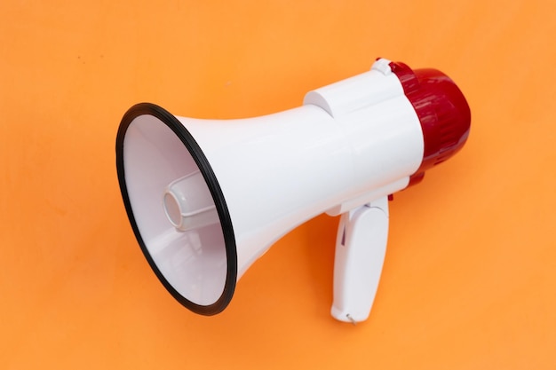 Red and white megaphone on orange background