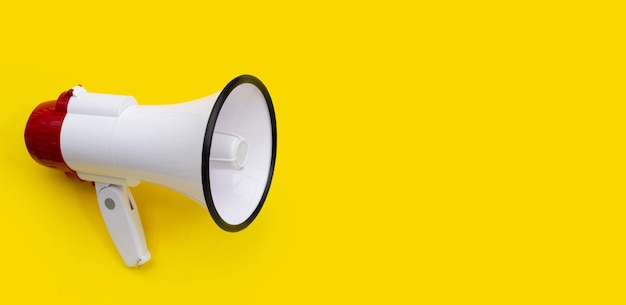 Red and white megaphone on yellow background.