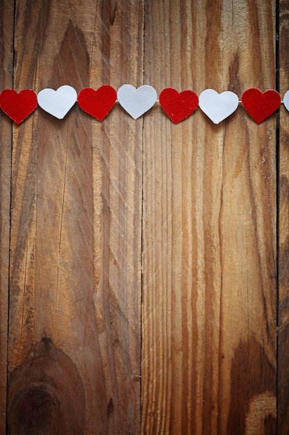 Red and White Ppaper hearts on the clothesline On  wood backgrou