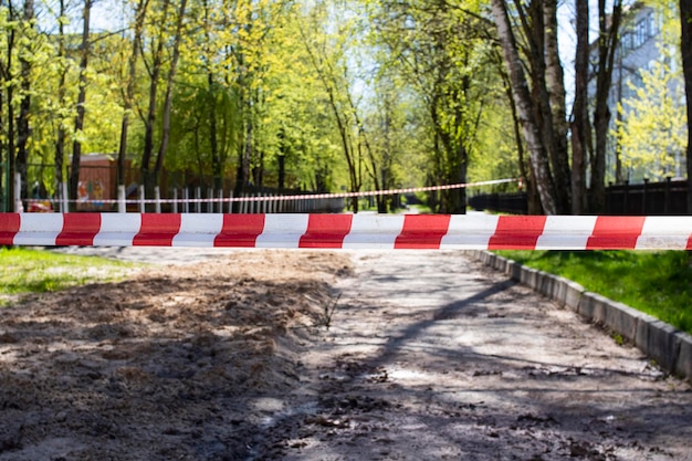 Red and white safety tape in the park