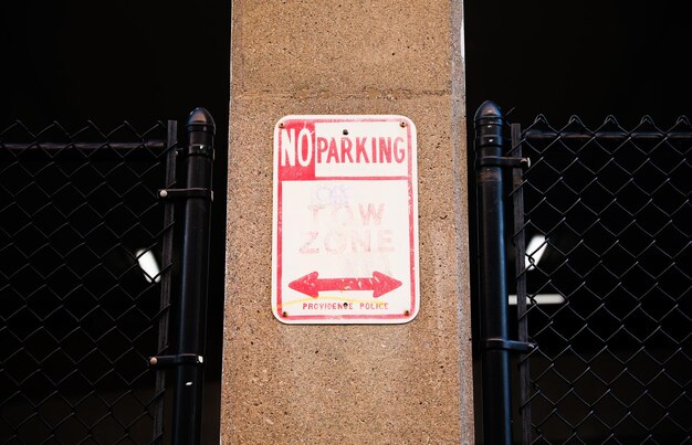 A red and white sign that says no parking.