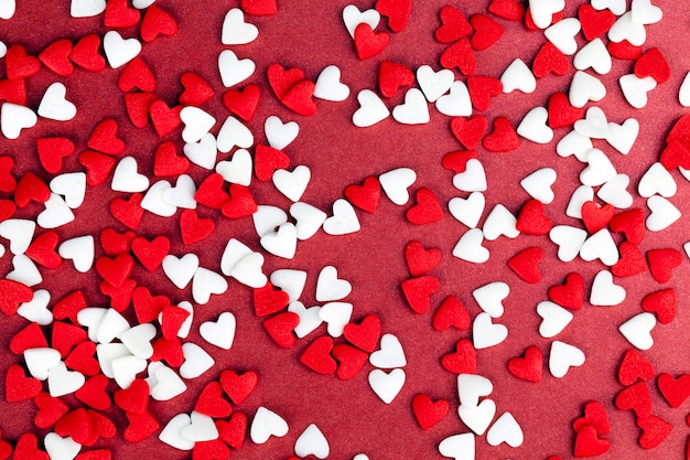 Red and white sweet heart shaped candies for decorating desserts and cakes