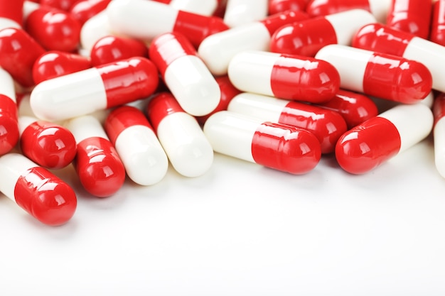 Red and white tablets on a white background with free space.