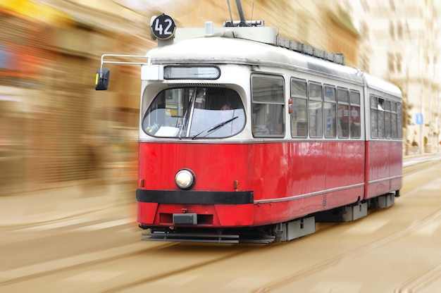 Photo a red and white tram with the number 42 on it.