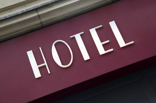 Red and White White Hotel Sign on Building Facade