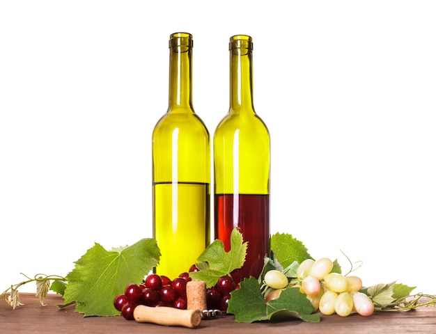 Red and white wine in bottles on the wooden table