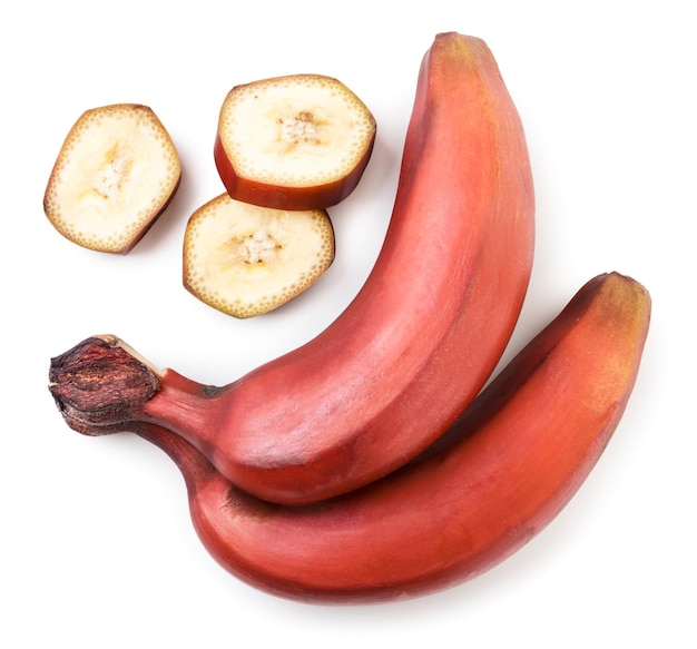 Red whole bananas and slices closeup on a white background isolated Top view