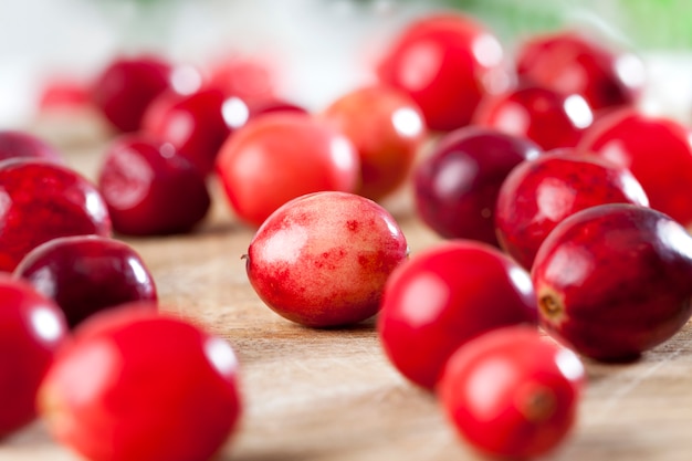 Red whole sour healthy cranberries, red ripe whole berries cranberries on the table, homemade cranberries grown in an industrial garden