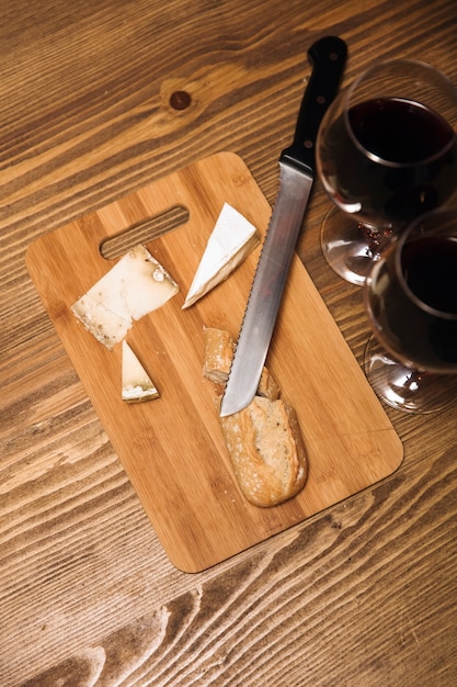 Red wine and assorted cheese plate with sausage