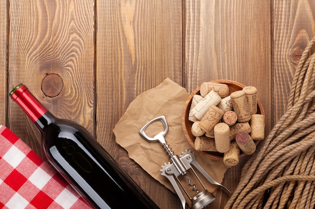 Red wine bottle bowl with corks and corkscrew