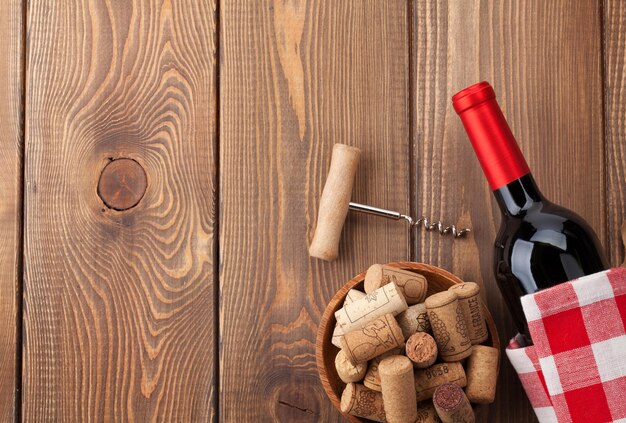 Red wine bottle bowl with corks and corkscrew