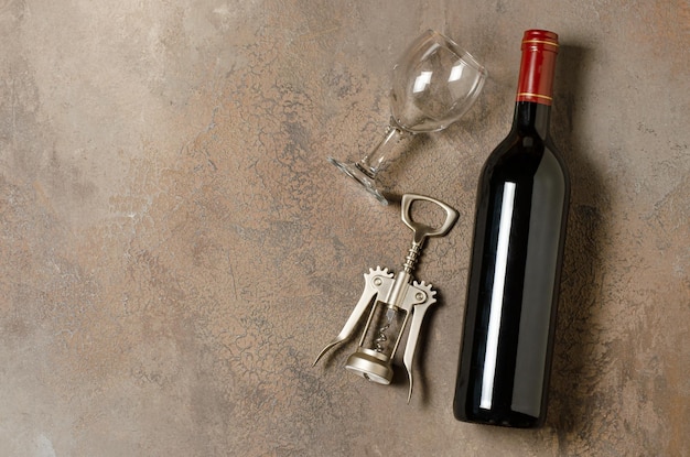 Red wine in a bottle Brown concrete background Flat lay Copy space