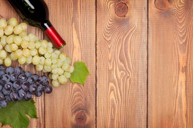 Red wine bottle and bunch of grapes