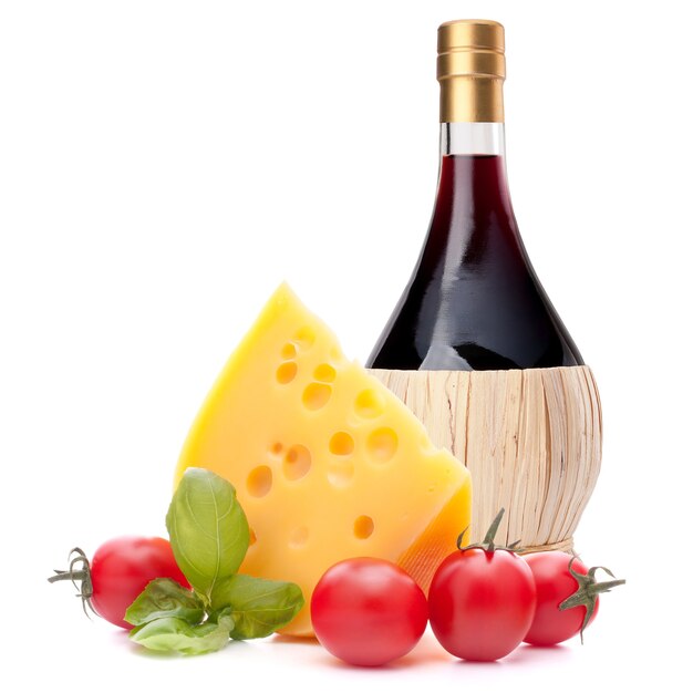 Red wine bottle, cheese and basil leave still life isolated on white background cutout. Italian food concept.