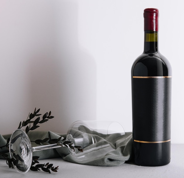 Red wine bottle and empty glass