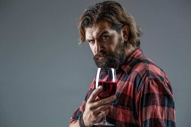 Red wine in bottle wine glass Red wine in a glass Sommelier man degustator winery Man