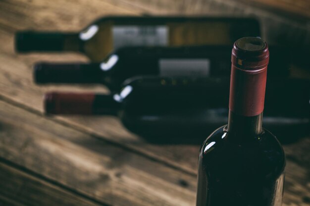 Red wine bottle on wooden background