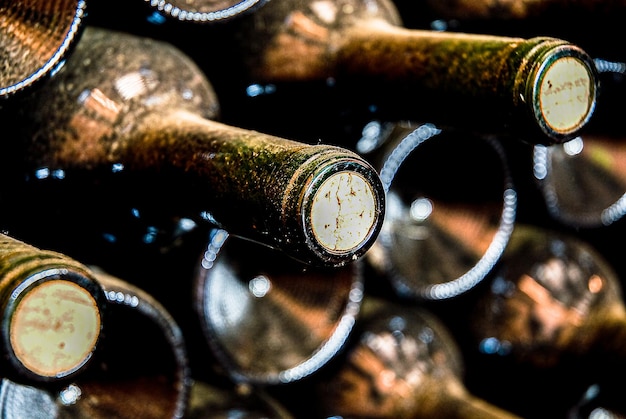 Red wine bottles laid down in the aging process to balance aromas and flavors.