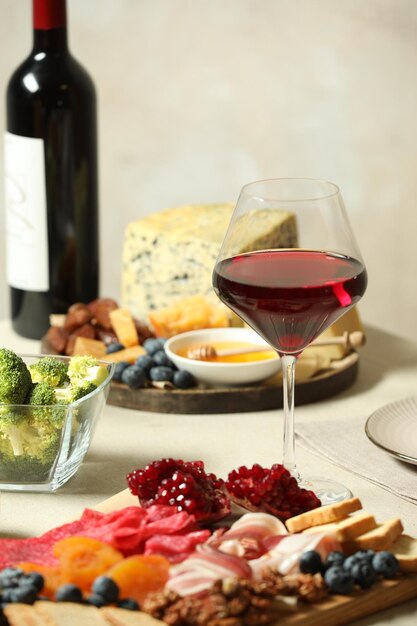 Red wine and different snacks served on table