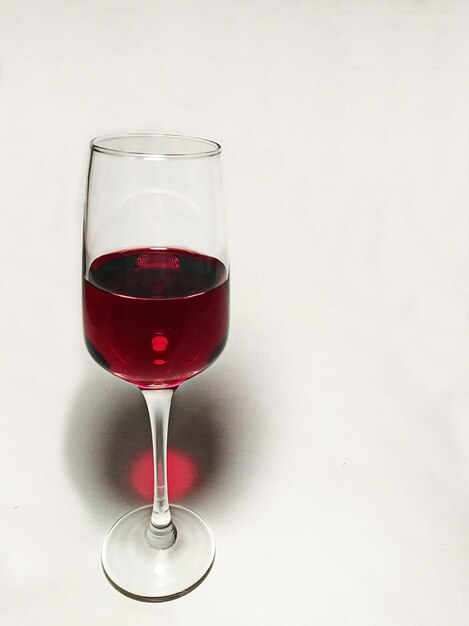 Red wine in glass against white background