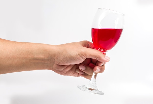 Red wine glass in hand on white background