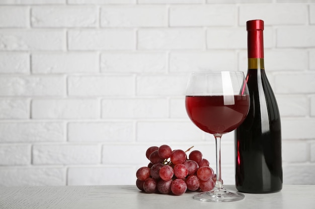 Red wine and grape on brick wall background