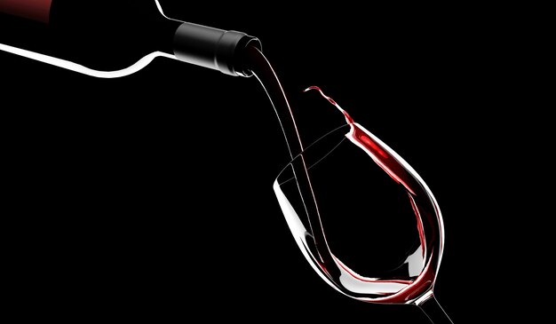 Il vino rosso viene versato dalla bottiglia in un bicchiere sul nero