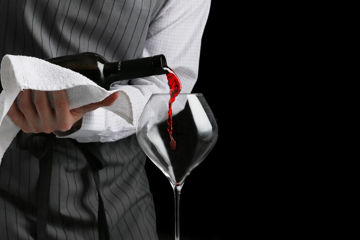 Photo red wine poured in glass by bartender