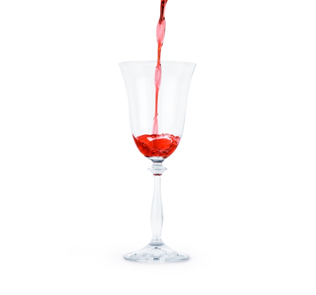 Red wine poured in a glass isolated on white