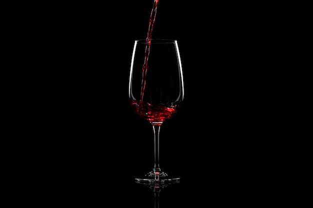 Red wine pouring into a wine glass