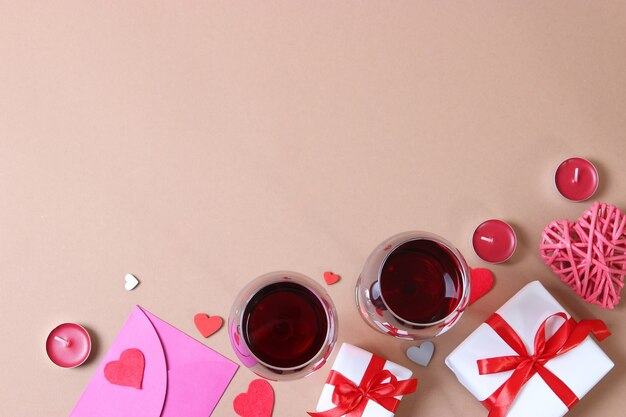 Red wine and roses on the table valentines day background