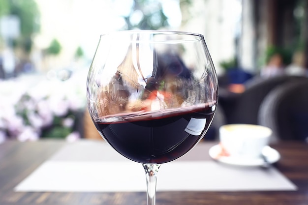 red wine splashing in a glass / glass with red wine in a cafe